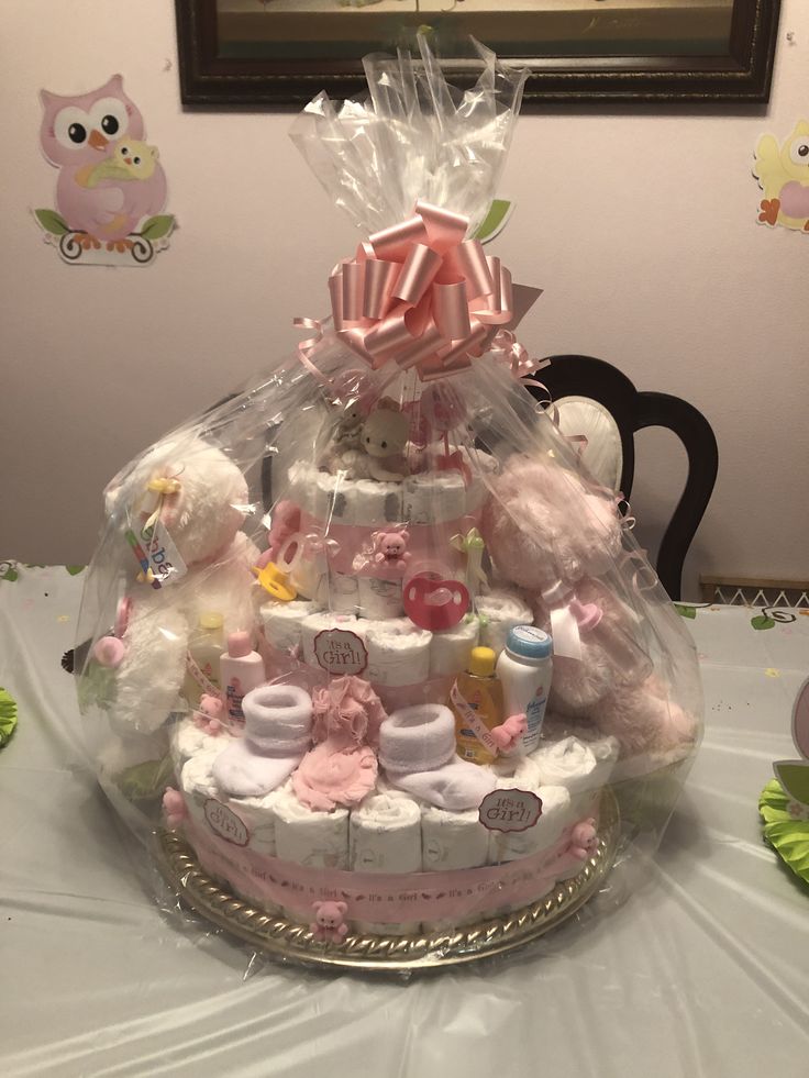 a baby shower cake with teddy bears and diapers