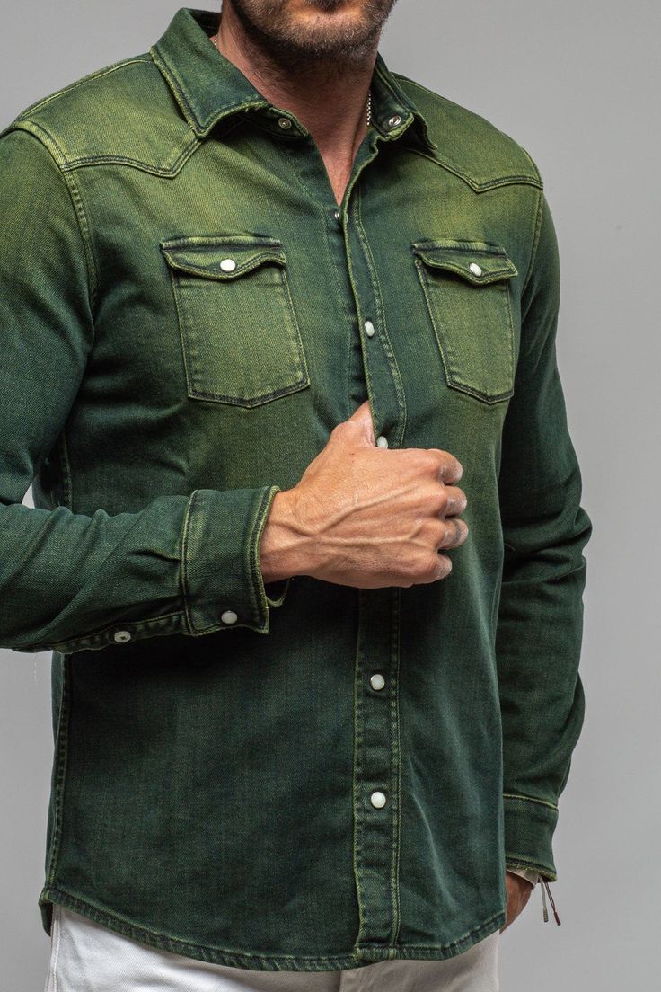 We have for years been searching for a fabric to create the perfect Axel's denim shirt; one with enough stretch for comfort, and a beefy, not 'boardy' look and feel. Finally, we've found exactly what we'd been searching for... but better! Individually dyed, washed and vintaged by Italian artisans, the Roper denim snap shirt features profound Western inspiration, but with a precision that only the Italians can accomplish with clothing. 94% cotton, 6% elastane [Stretch Denim] Pearlized Snaps Weste Western Denim Shirt Men, Green Shirt Men, Western Inspiration, Athletic Build, Western Denim Shirt, Hotel Bedroom, Actor John, Denim Shirt Men, Denim Shirts