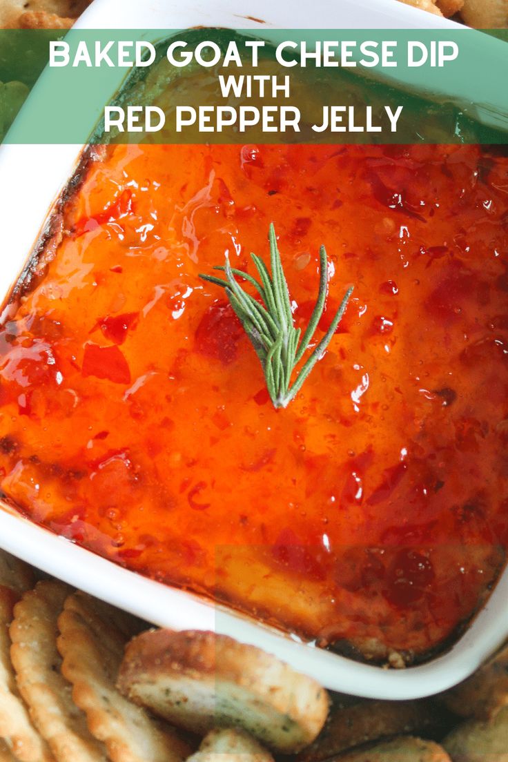 baked goat cheese dip with red pepper jelly in a white dish surrounded by crackers