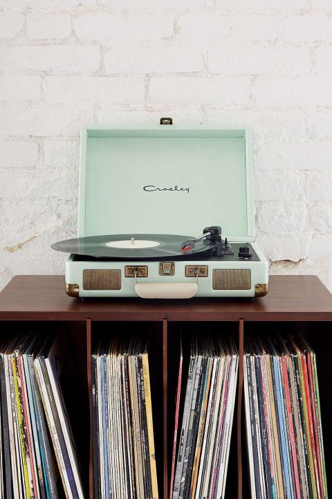 an old record player sitting on top of a wooden shelf