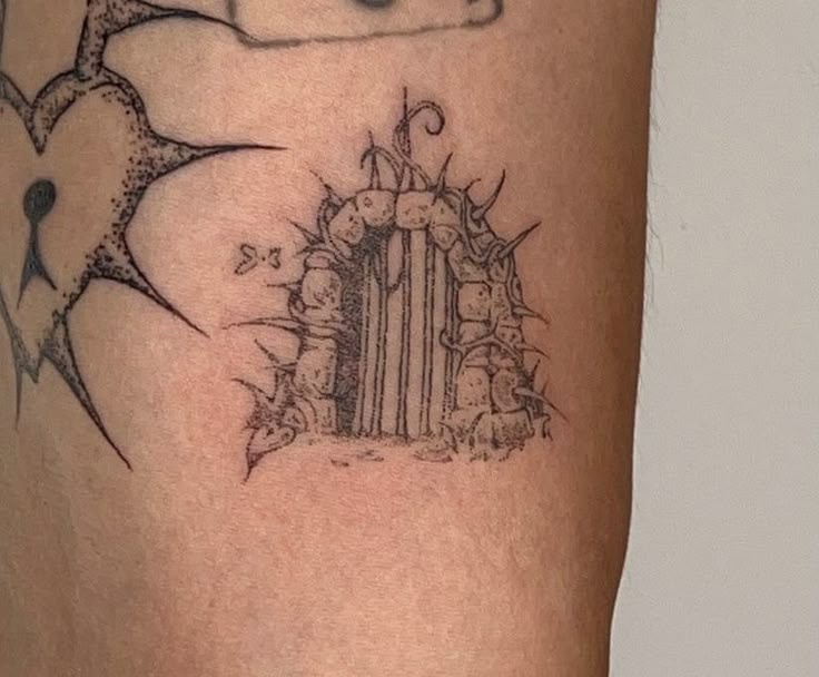 a tattoo on the leg of a person with a card in front of them and an envelope behind it