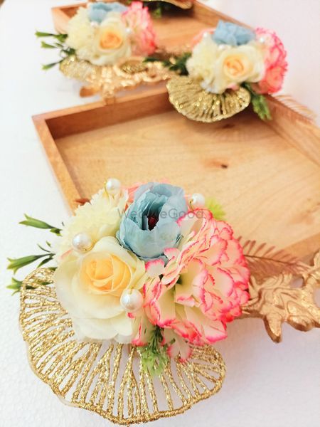 two wooden trays filled with flowers on top of a white table next to each other