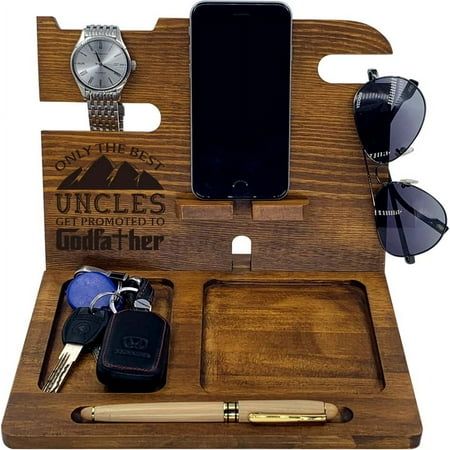 an iphone, sunglasses, cell phone and keys in a wooden holder