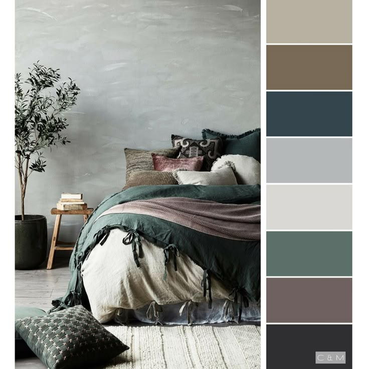 a bedroom with grey walls and green bedding, pillows and throw pillows on the floor