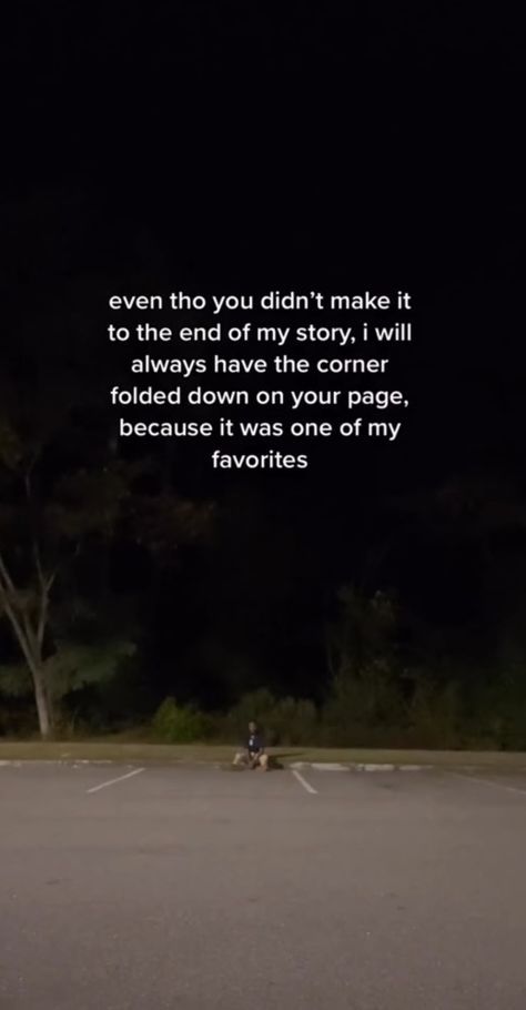 a person riding a motorcycle in the middle of a parking lot at night with a quote written on it