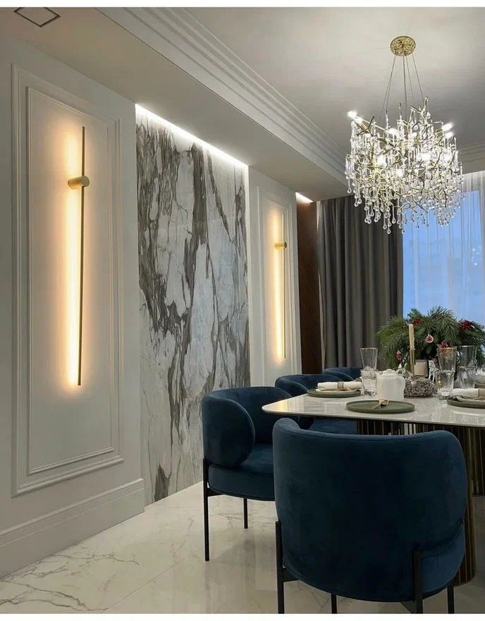 an elegant dining room with blue chairs and a chandelier hanging from the ceiling