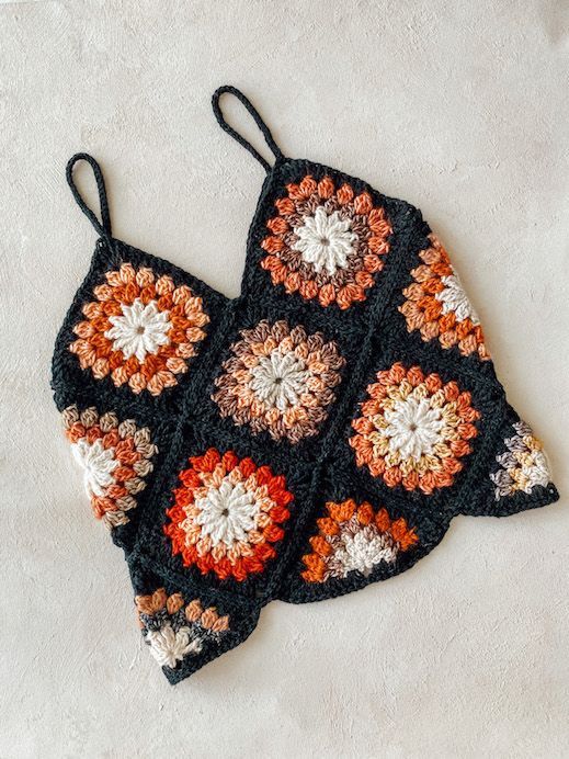 two crocheted potholders sitting on top of a white surface