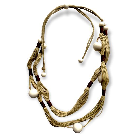 Double loop, multi-stand necklace with wooden beads. Taking advantage of natural resources, this artisan leverages wood as the primary component of this striking fiber art necklace. You can adjust the length for a personalized fit. Consider pairing it with: balancing geometry studs, globally inspired hanging drop earrings, fan shaped brass earrings, convex statement ring or the interlocking knotted bracelet Details: Adjustable length necklace allows for personalized fit Size: Length of necklace Adjustable Wooden Beads Necklace In Nature-inspired Style, Earthy Adjustable Multi-strand Necklace, Earthy Multi-strand Adjustable Necklace, Adjustable Natural Wooden Beaded Necklaces, Adjustable Beige Beaded Necklace With Wooden Beads, Adjustable Beige Beaded Necklaces With Wooden Beads, Adjustable Beige Wooden Beaded Necklaces, Artisan Brown Handwoven Necklace, Unique Multi-strand Wooden Beaded Necklaces