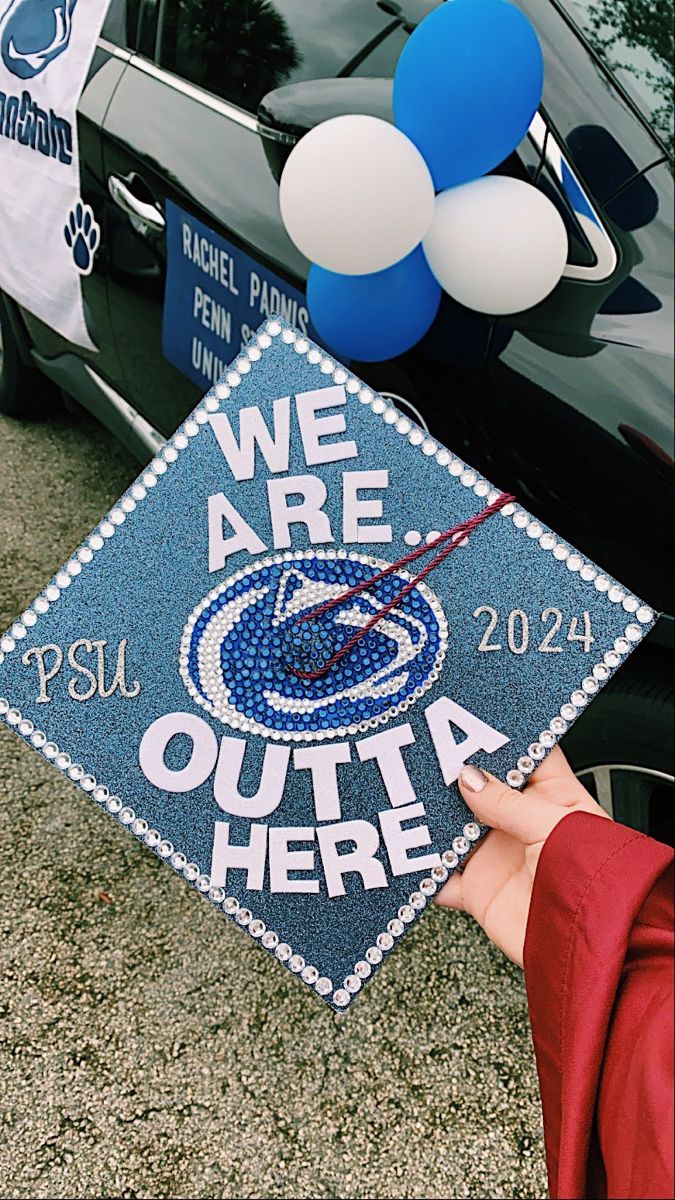 a graduation cap with the words we are out in front of a car