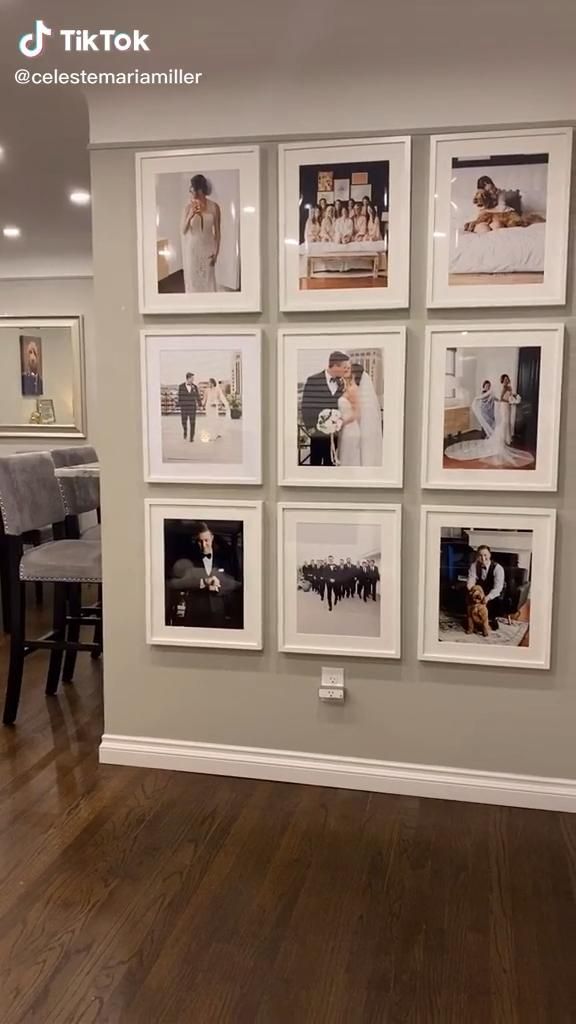 a living room with pictures hanging on the wall