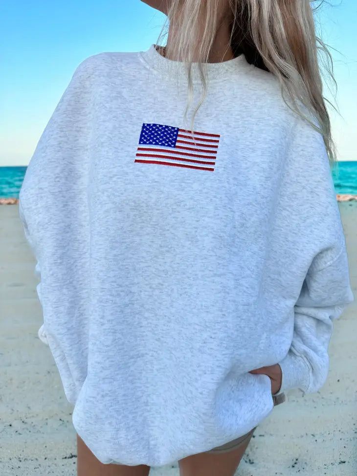 The American Flag Embroidered Sweatshirt - A classic crewneck sweatshirt with embroidered American Flag detail -Model is 5'3" and wearing a size Large Trendy Sweatshirts Hoodie, Sweatshirts For School, Trending Sweatshirts, Brandy Sweatshirt, Preppy Hoodies, Crewnecks For Women, Trendy Crewneck Sweatshirt, Hoodies Cute, American Flag Sweatshirt