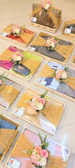 there are many pictures on the table with flowers in them and some cards laid out