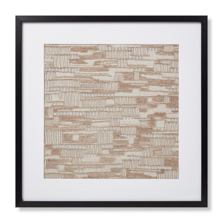 a brown and white print with black frame on the wall above it is an abstract pattern