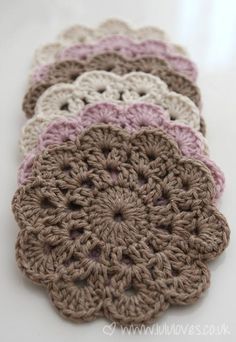 crocheted coasters are arranged on a table