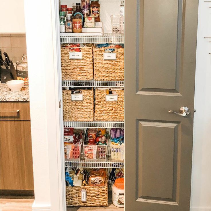 an open pantry door with baskets and food in it