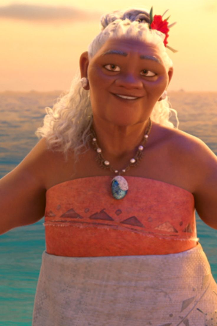 a woman in an orange and white dress standing next to the ocean with her hands on her hips