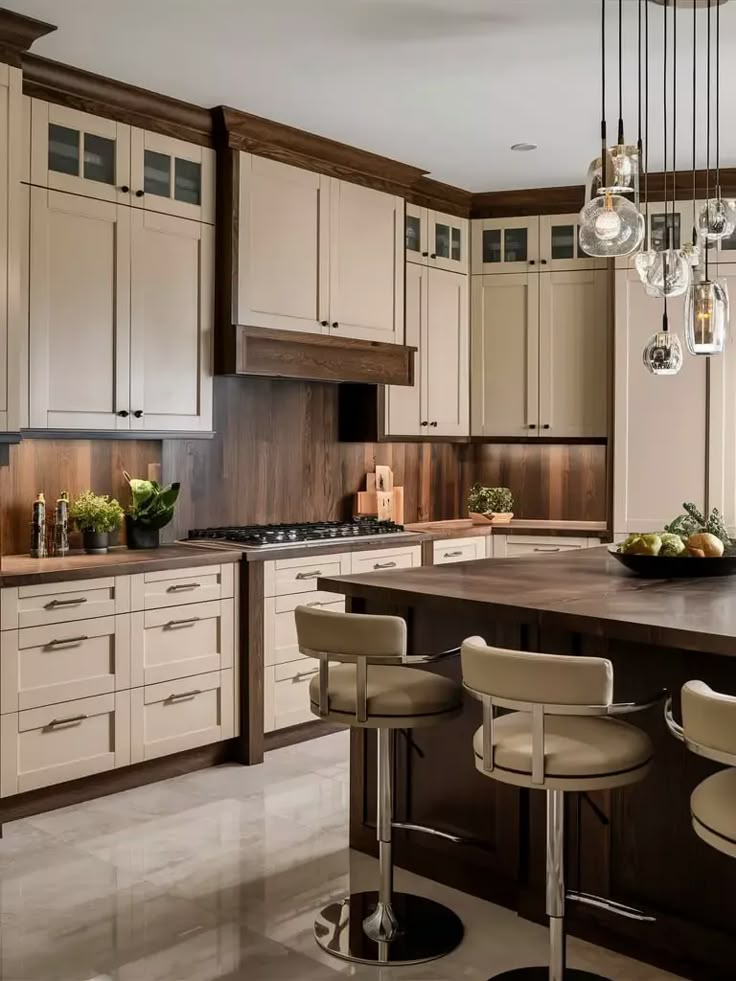 a kitchen with white cabinets and brown counter tops, two bar stools at the center