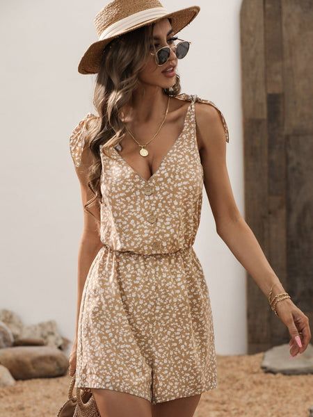 The EMES SHOP romper is detailed with a cute tie shoulder design. Features a v neck line. ditsy floral print. button front. and regular fit. Pair it with a sun hat and sunnies for a fun summer look.MATERIALS: 100% Blended cottonMEASUREMENTS: Product length is 31"- 34" in 4-6-Small | Waist: 25?26.5?in | Chest: 33?34.5?in | Hips: 35?36.5?in 6-8-Medium | Waist: 26.5?28?in | Chest: 34.5?36?in | Hips: 36.5?38?in 8-10-Large | Waist: 28?29.5?in | Chest: 36?37.5?in | Hips: 38?39.5?in 10-12-X-Large | ... Trendy Beach Sundress With Adjustable Straps, Casual V-neck Sundress For Summer Outings, Trendy Printed Jumpsuits And Rompers For Summer, Summer Jumpsuits And Rompers With Adjustable Straps, Summer Vacation Printed Jumpsuits And Rompers, Printed Summer Jumpsuits And Rompers For Day Out, Casual Summer Jumpsuits And Rompers With Tie Straps, Printed Jumpsuits And Rompers For Summer Vacation, Casual Summer Jumpsuits With Tie Straps