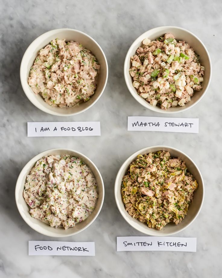 four bowls filled with different types of food on top of a table next to each other