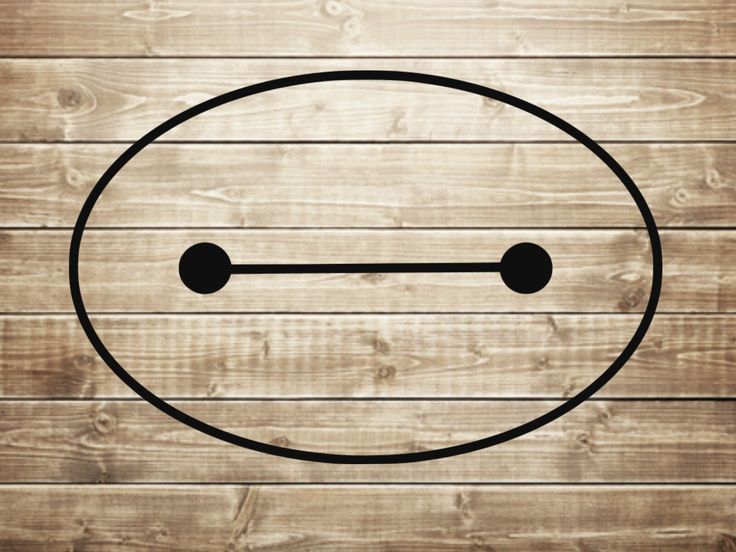 a wooden wall with a smiley face drawn on it's side and two black dots in the middle