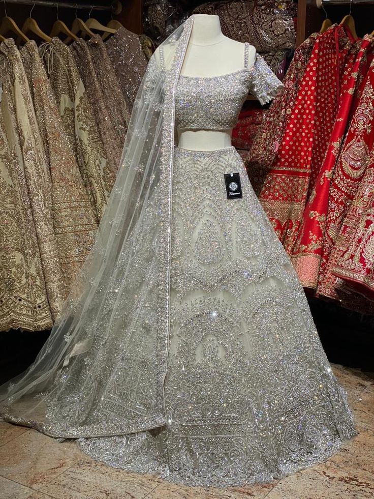 Iced cube sliver lehenga with frosted crystal embroidery teamed with a spaghetti strap blouse with crystal embroidery and net dupatta. Fabric: Net Custom designed according to client measurements and color preference. Production and delivery time is 120 days! Silver Hand Embellished Sharara For Festive Occasions, Festive Silver Hand Embellished Sharara, Festive Silver Hand Embellished Dupatta, Festive Hand Embellished Silver Dupatta, Festive Silver Hand-embellished Dupatta, Silver Anarkali Style Hand Embellished Sharara, Silver Hand Embellished Anarkali Dupatta, Silver Anarkali Gown Hand Embellished, Designer Silver Embellished Dupatta