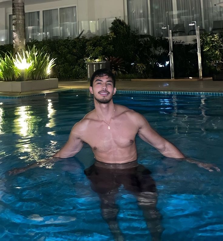 a man standing in the middle of a swimming pool