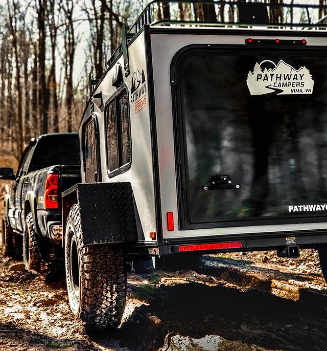 an off road vehicle parked in the woods