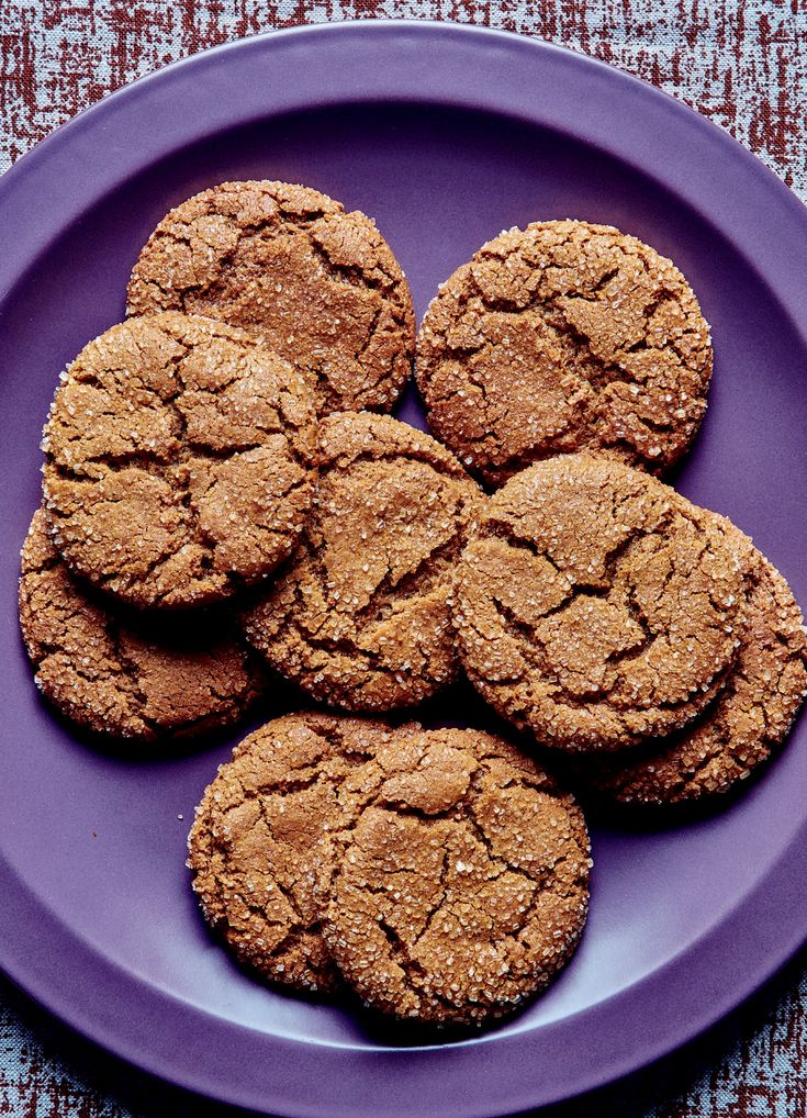 a purple plate topped with cookies on top of a table