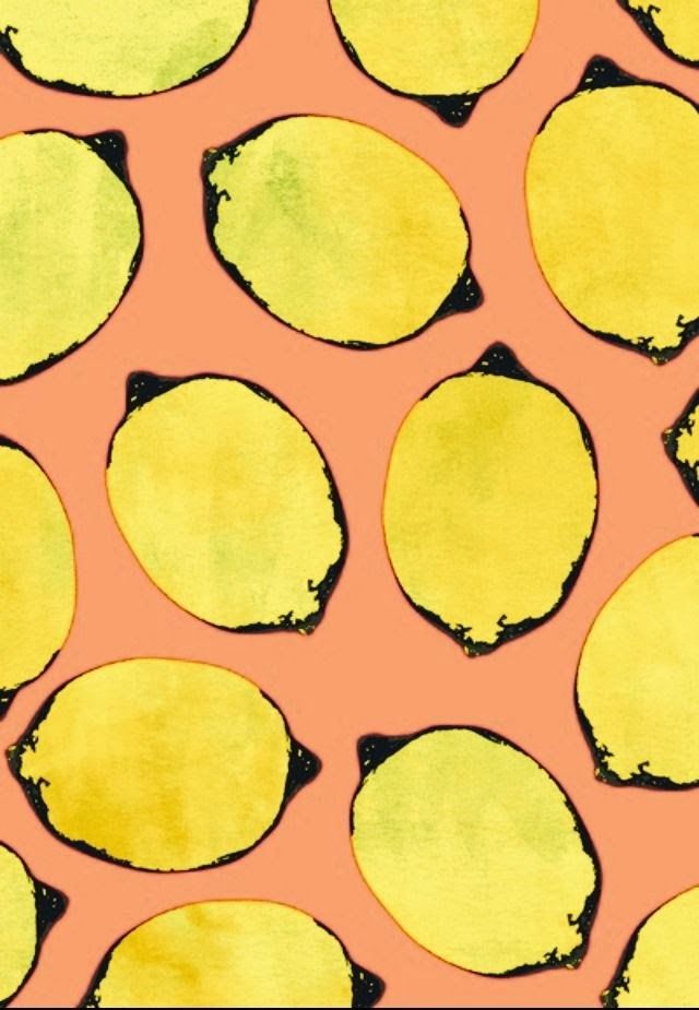 an orange and yellow background with black spots on it's edges, in the center is a pattern of lemons