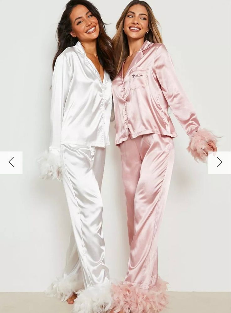 two women in pink and white pajama's standing next to each other