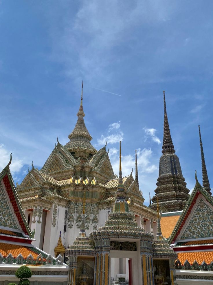 an ornate building with many spires on it's sides and blue sky in the background