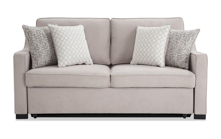 a light colored couch with pillows on the arm and backrests, in front of a white background