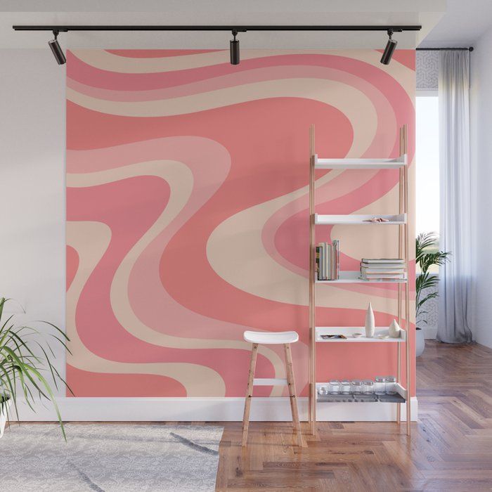 an abstract pink and white wall mural in a living room with a chair, book shelf and potted plant