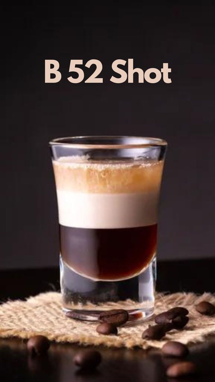 a shot glass filled with coffee beans and the words b 52 shot on top of it