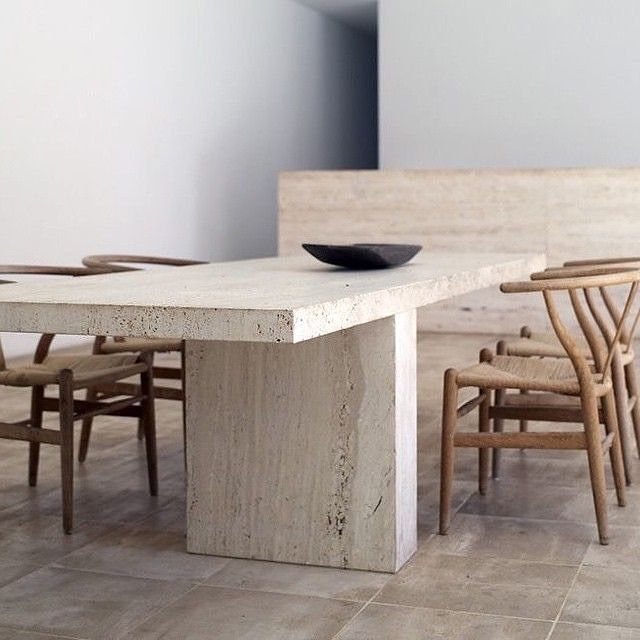 a table with chairs and a bowl on top of it in the middle of a room