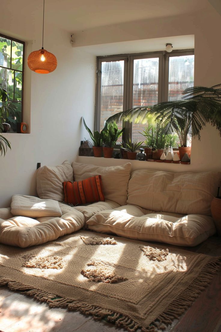 a living room filled with lots of furniture and plants