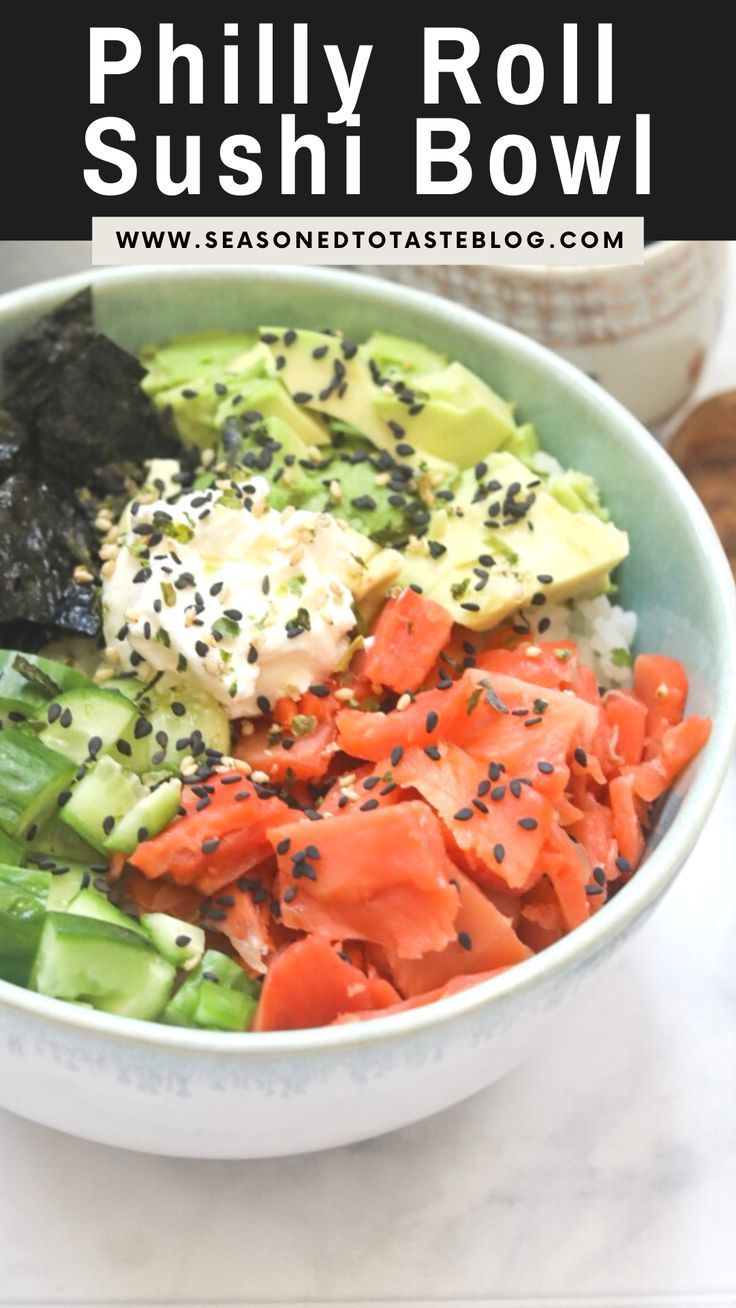 a bowl filled with sushi and vegetables on top of a table