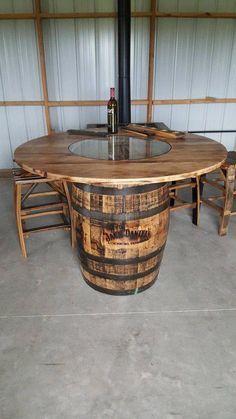 a table made out of wine barrels in a garage