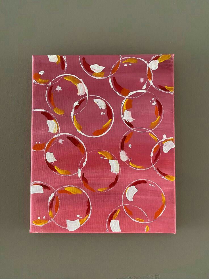 a pink square with circles painted on it