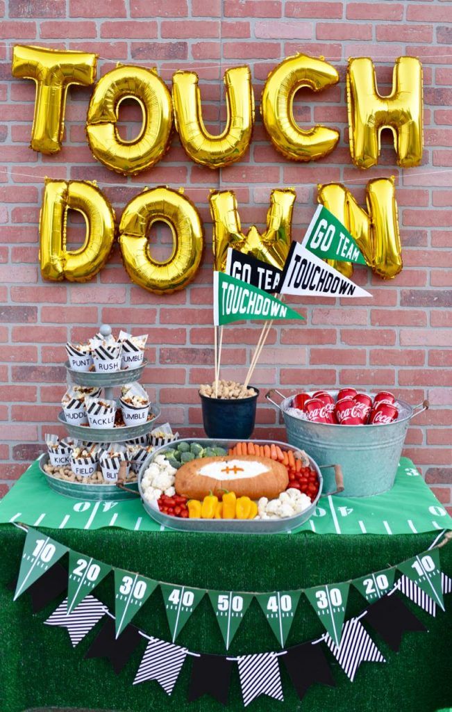 a table topped with lots of food next to a sign that says touch down on it