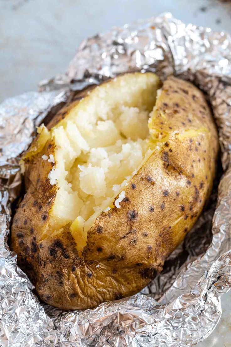 a baked potato sitting on top of tin foil