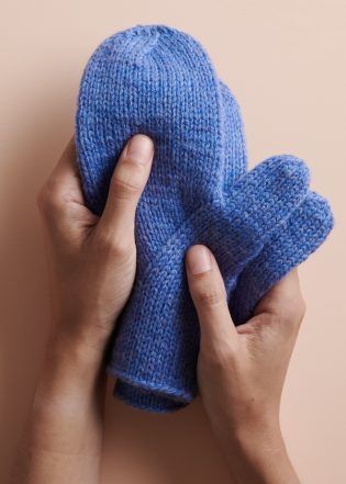 a person holding a blue mitt in their hands