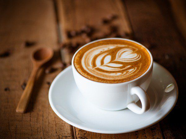 a cappuccino is sitting on a saucer