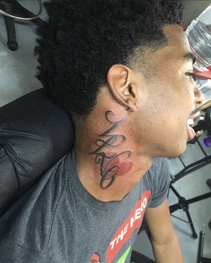 a man with a tattoo on his neck