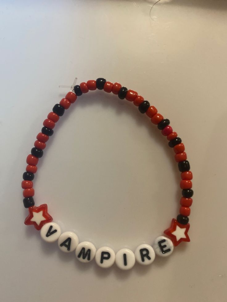 a beaded bracelet with the word vampire spelled out in white letters and red beads