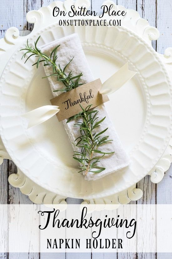 a white plate topped with napkins covered in greenery