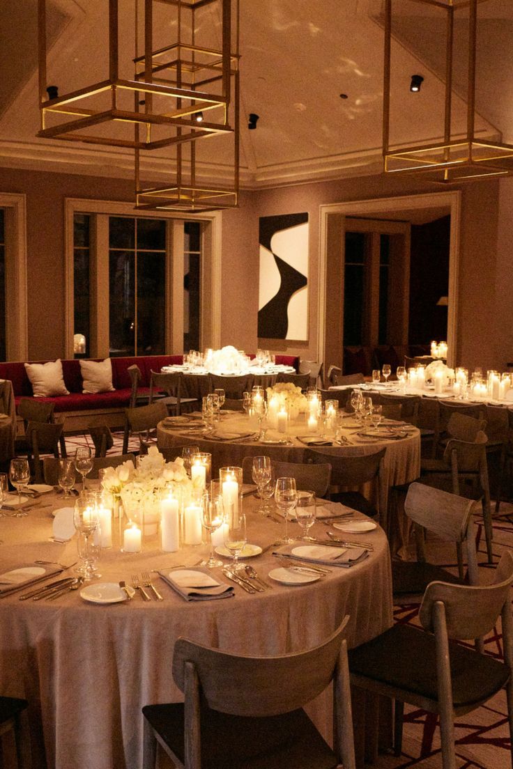 A luxurious wedding reception setup with round tables adorned with white floral centerpieces and surrounded by warm candlelight, creating an elegant and romantic ambiance. The scene is enhanced by chic decor and modern chandeliers, perfect for a high-end celebration. : #LuxuryWedding #WeddingReception #ElegantWedding #CandlelitWedding #WeddingInspiration Wedding Round Tables Ideas, Round Tables Candles Wedding, Wedding Reception Circle Tables, Round Table With Candles, Wedding Round Table Candles, Candlelit Wedding Reception Round Tables, Wedding Reception Round Tables, Candlelight Wedding, Wedding Set Up Reception