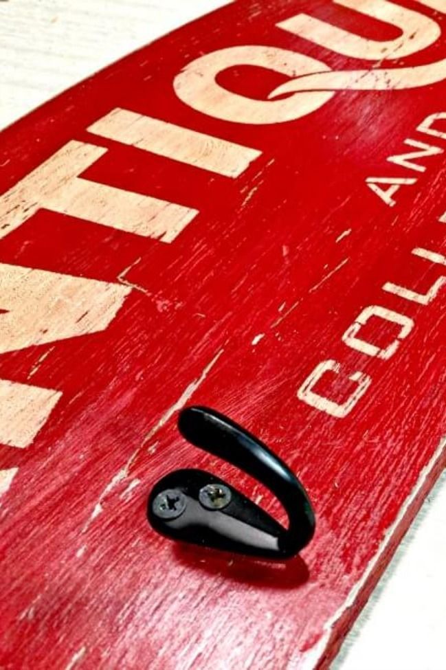 a close up of a red sign with black scissors on it's side,