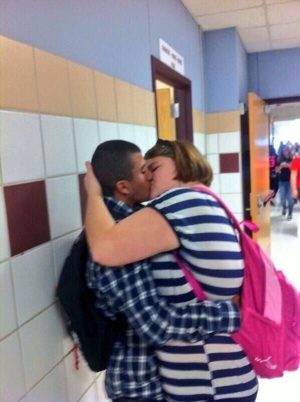 two people hugging each other in a hallway