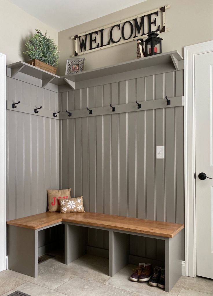 a wooden bench sitting under a welcome sign on top of a wall in a room